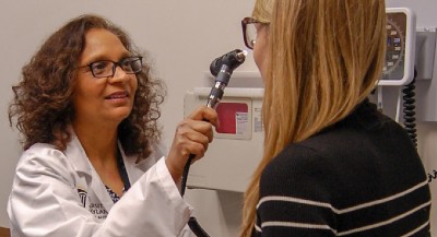 Kalpana Shere-Wolfe examines a patient